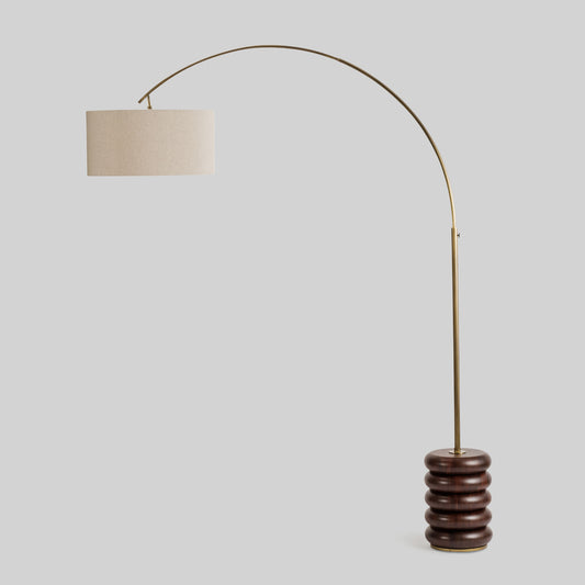 Floor lamp with a curved arm and wooden base on a light gray background.