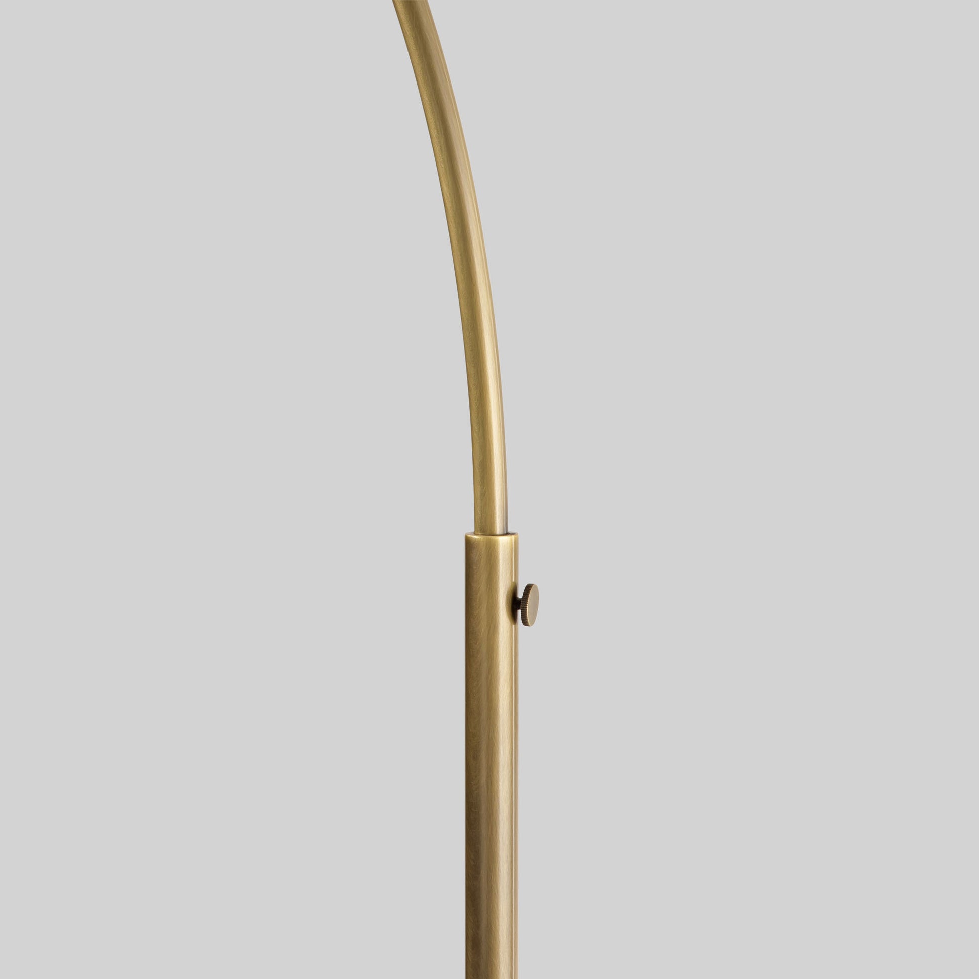 Floor lamp with a curved arm and wooden base on a light gray background.