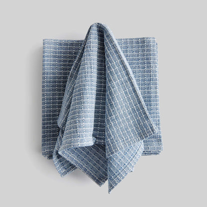 Blue windowpane square cotton dinner napkins set of 4, unfolded, with gray background.