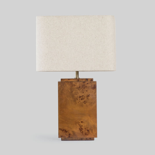 Burl wood table lamp on a light gray background.