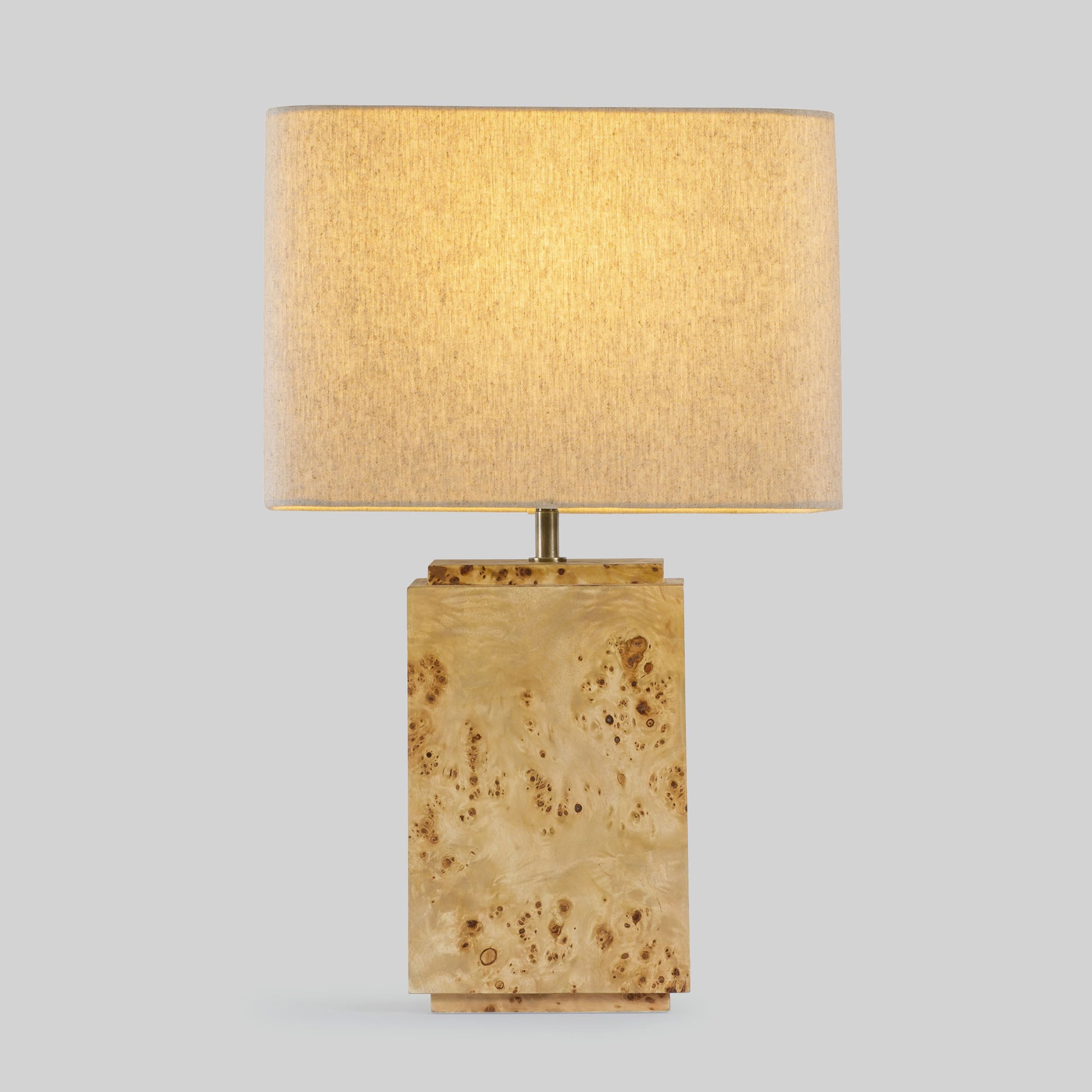 Burl wood table lamp on a light gray background.