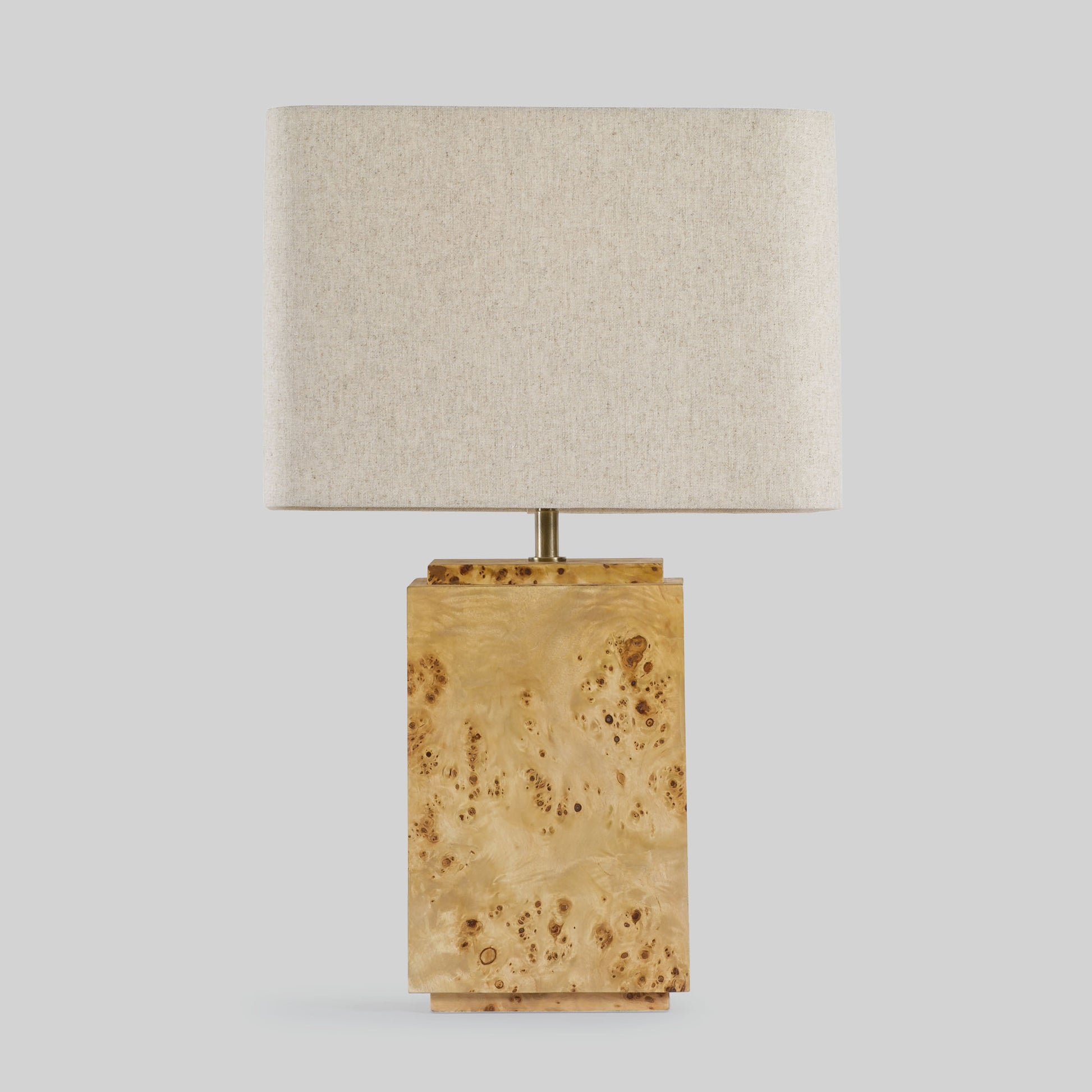 Burl wood table lamp on a light gray background.
