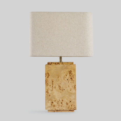 Burl wood table lamp on a light gray background.