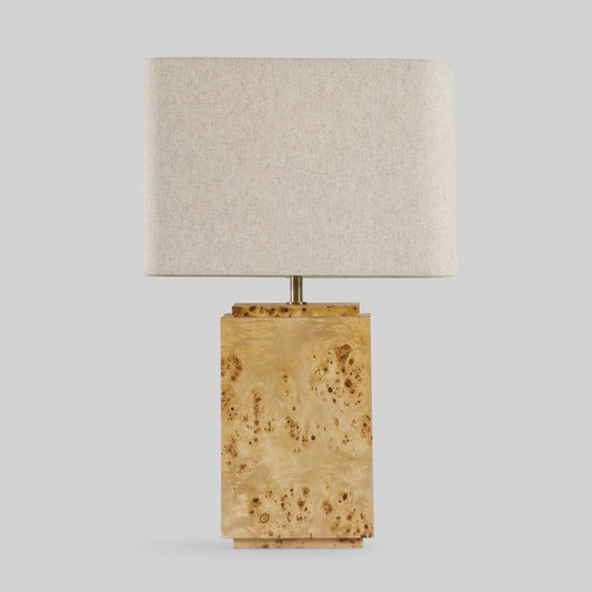 Burl wood table lamp on a light gray background.
