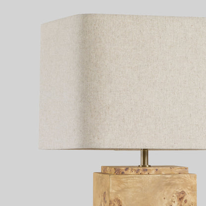 Burl wood table lamp on a light gray background.