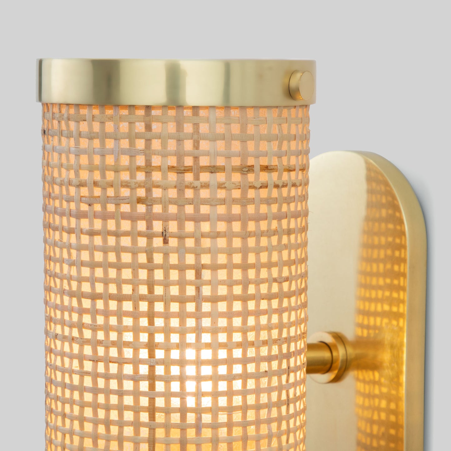Wall-mounted light fixture with gold trim and textured glass on a gray background.