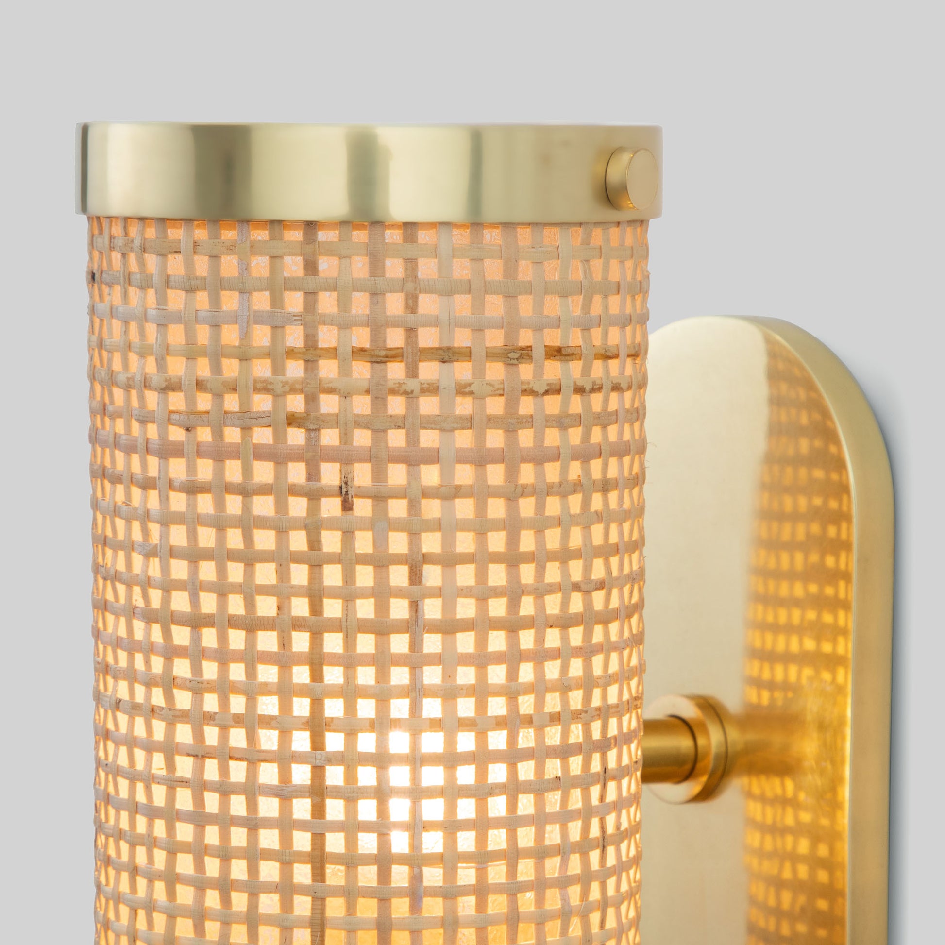 Wall-mounted light fixture with gold trim and textured glass on a gray background.