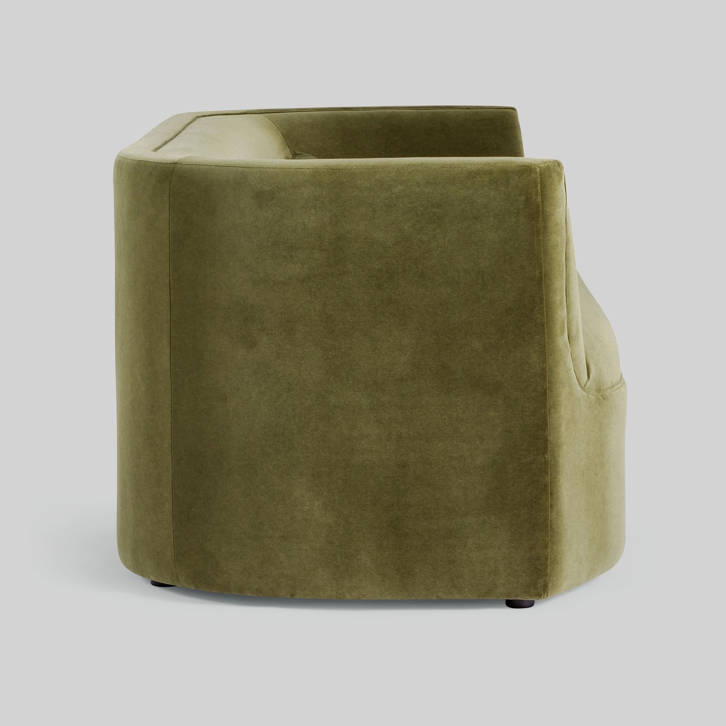 Green fabric sofa on a light gray background.