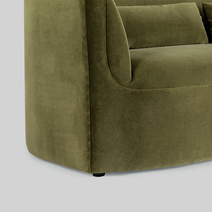 Green fabric sofa on a light gray background.