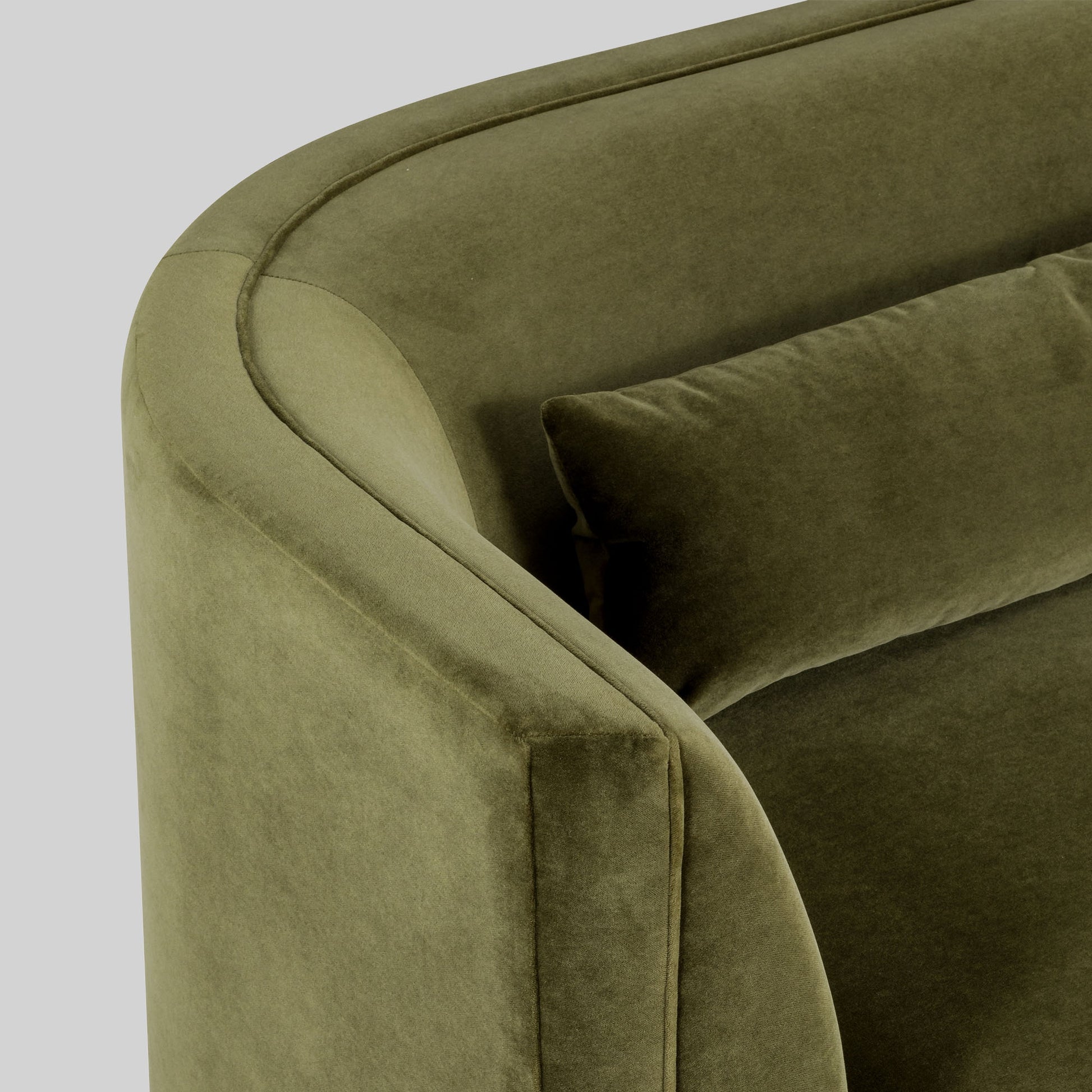 Green fabric sofa on a light gray background.