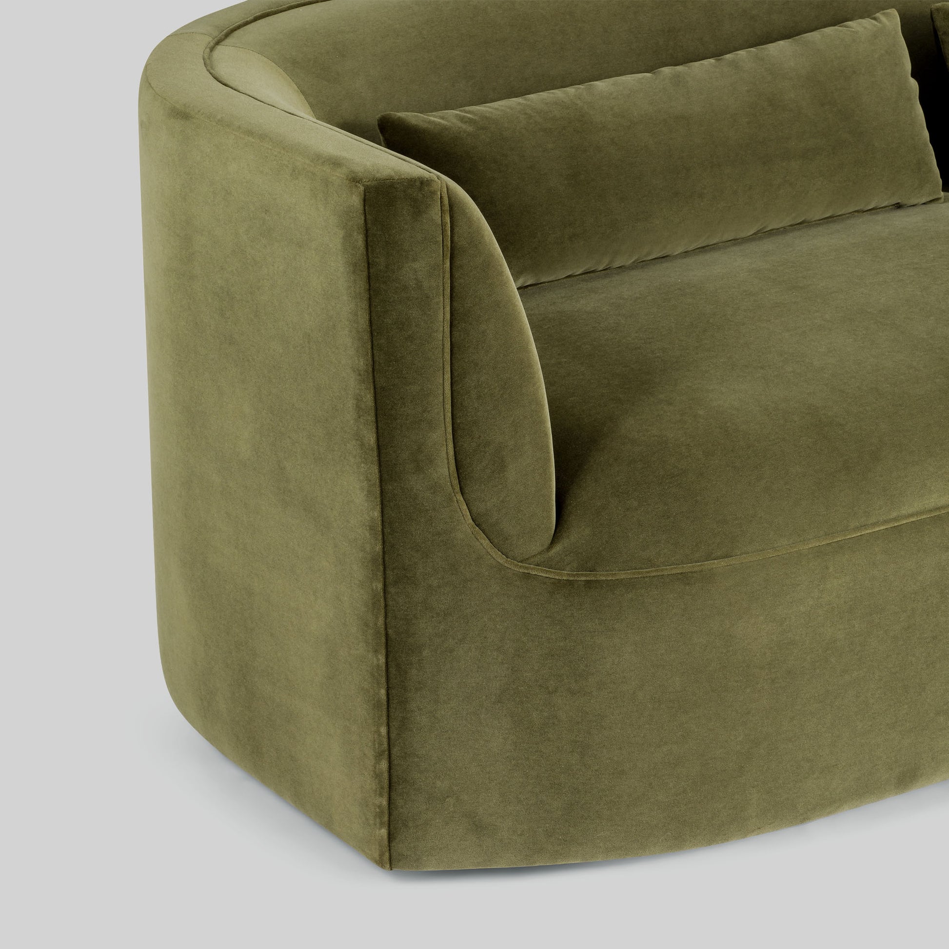 Green fabric sofa on a light gray background.