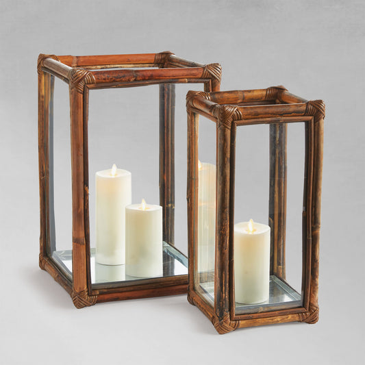 Cane rattan hurricane candleholders with gray background.