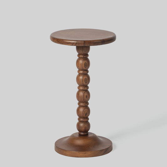 Round wooden side table with spindle design on a light gray background.