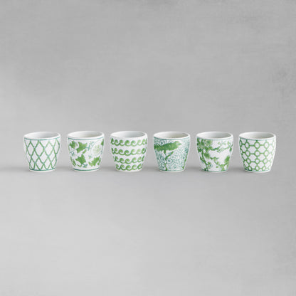 Set of 6 chinoiserie green and white porcelain flower pots lined up in a row with gray background.