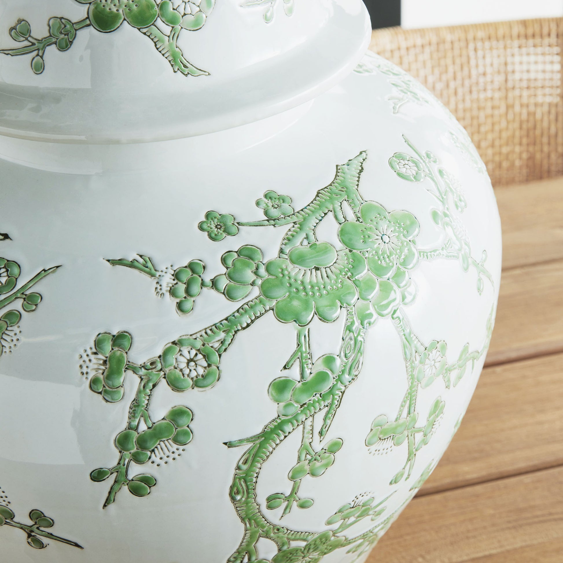 Chinoiserie green and white porcelain ginger jar, closeup view of side design.