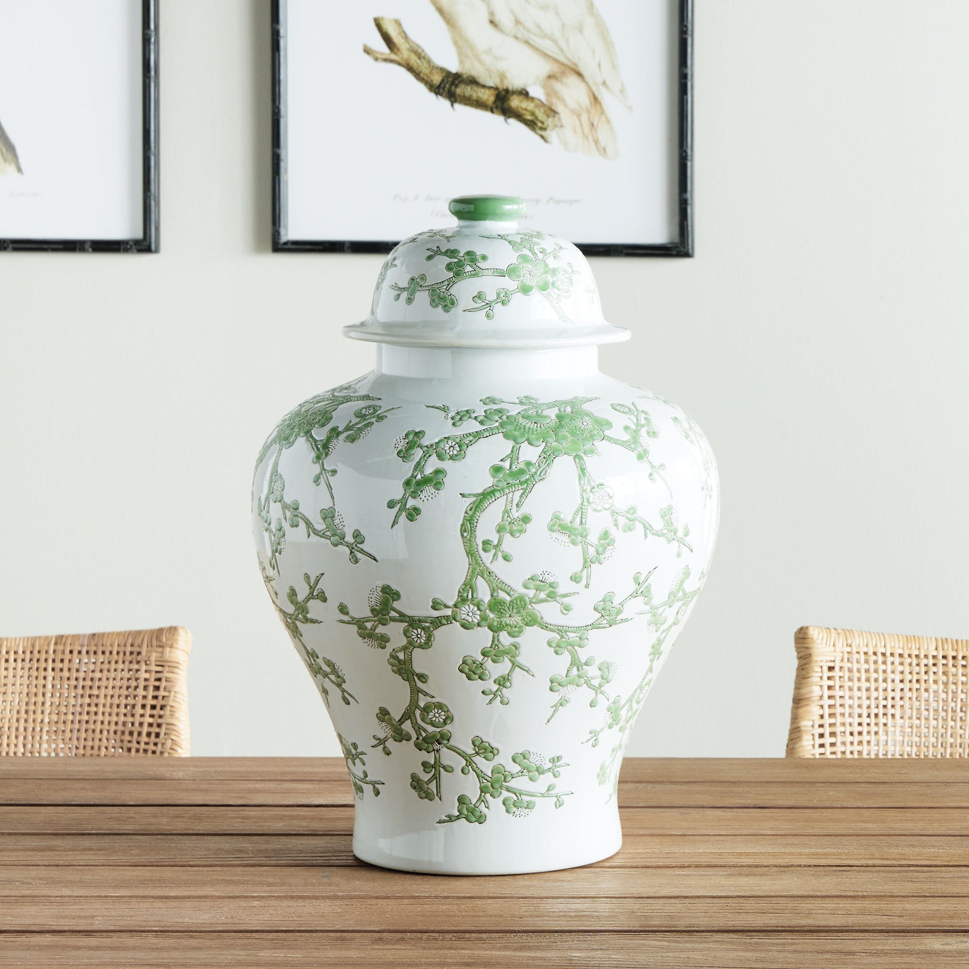 Chinoiserie green and white porcelain ginger jar stylized on wooden dining table.