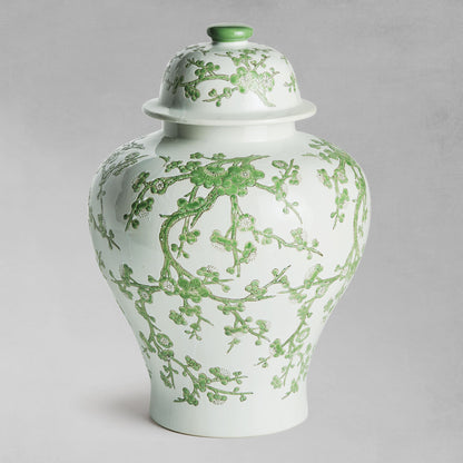 Chinoiserie green and white porcelain ginger jar with gray background.