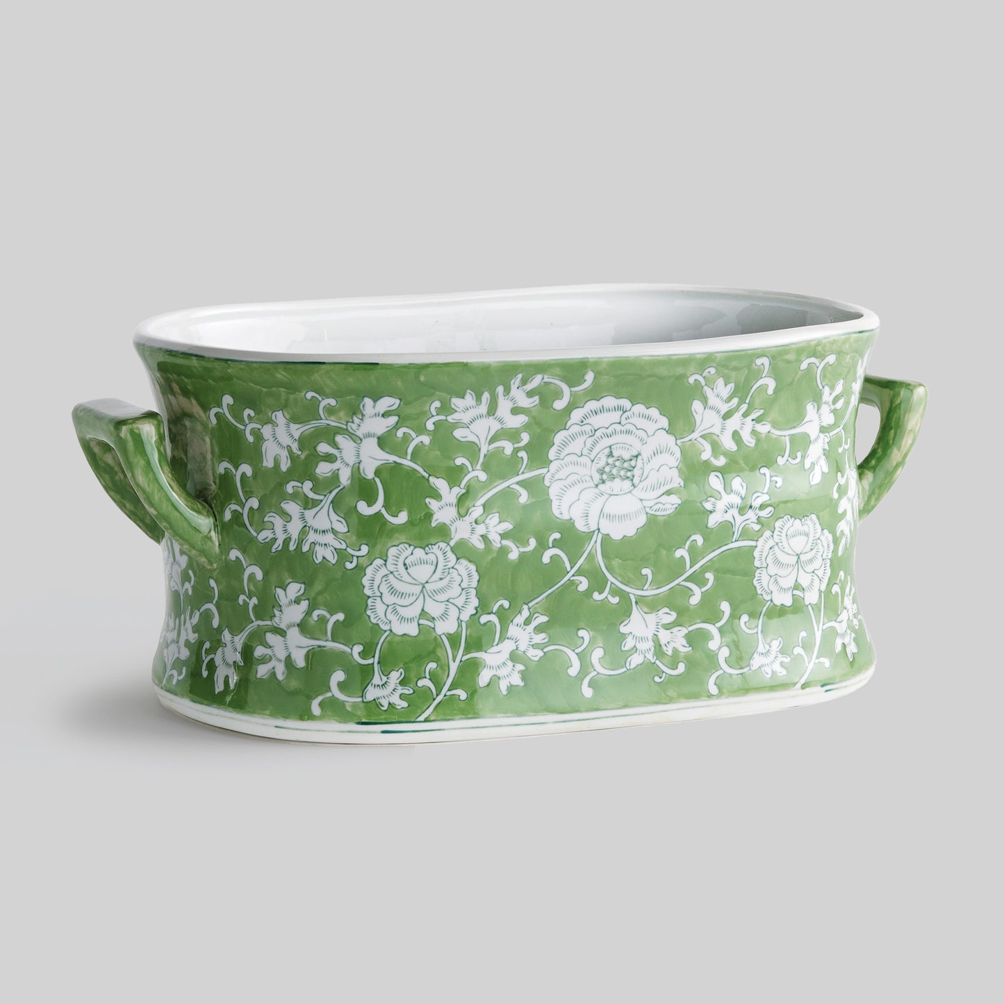 Chinoiserie green and white porcelain planter with gray background.