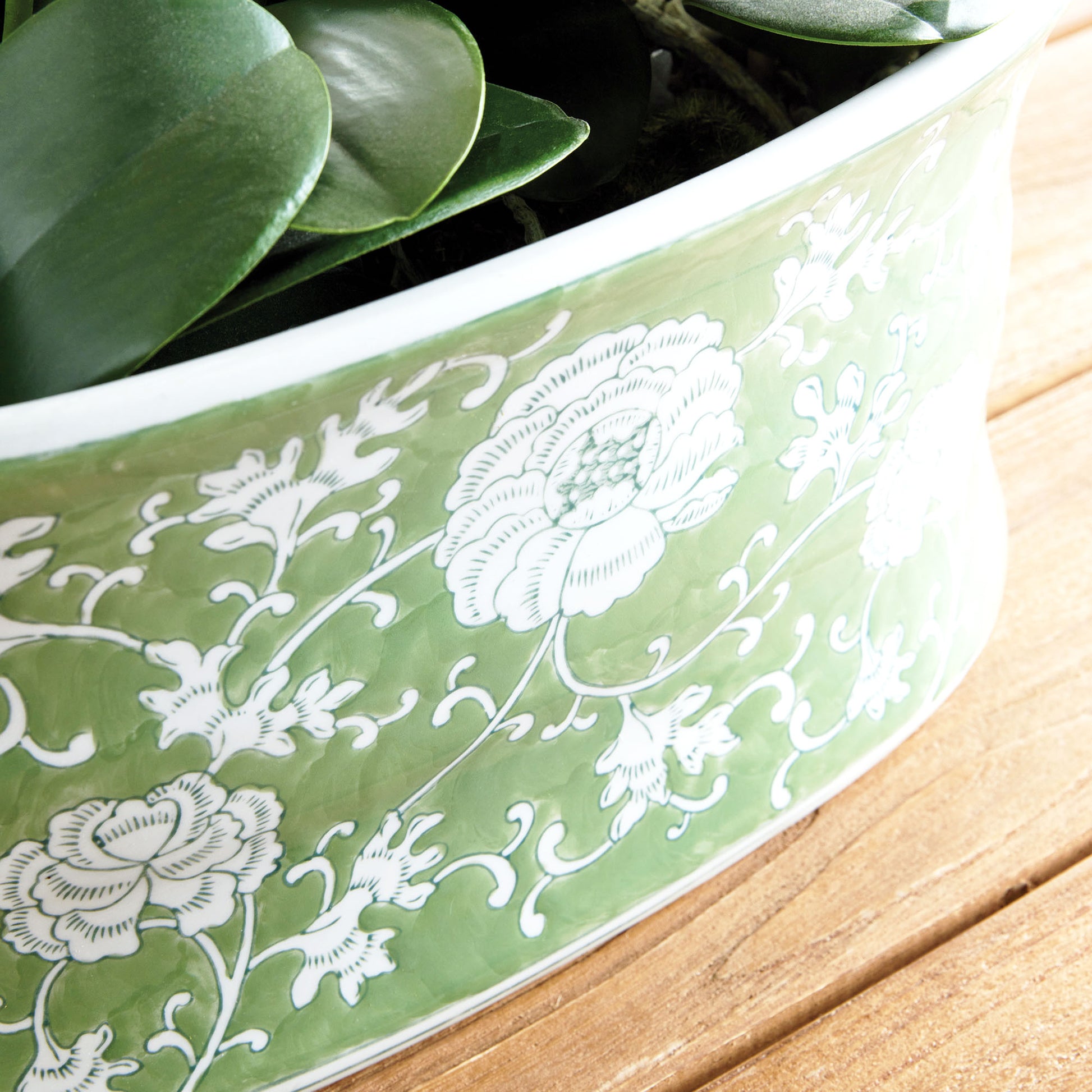 Chinoiserie green and white porcelain planter closeup view of planter design.