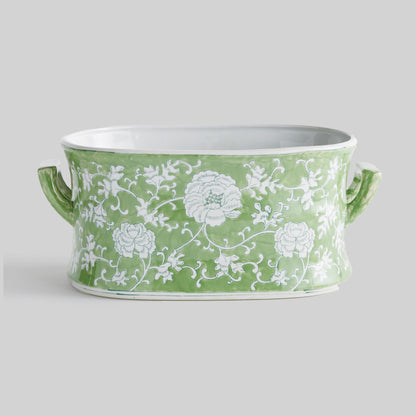 Chinoiserie green and white porcelain planter, side view, with gray background.