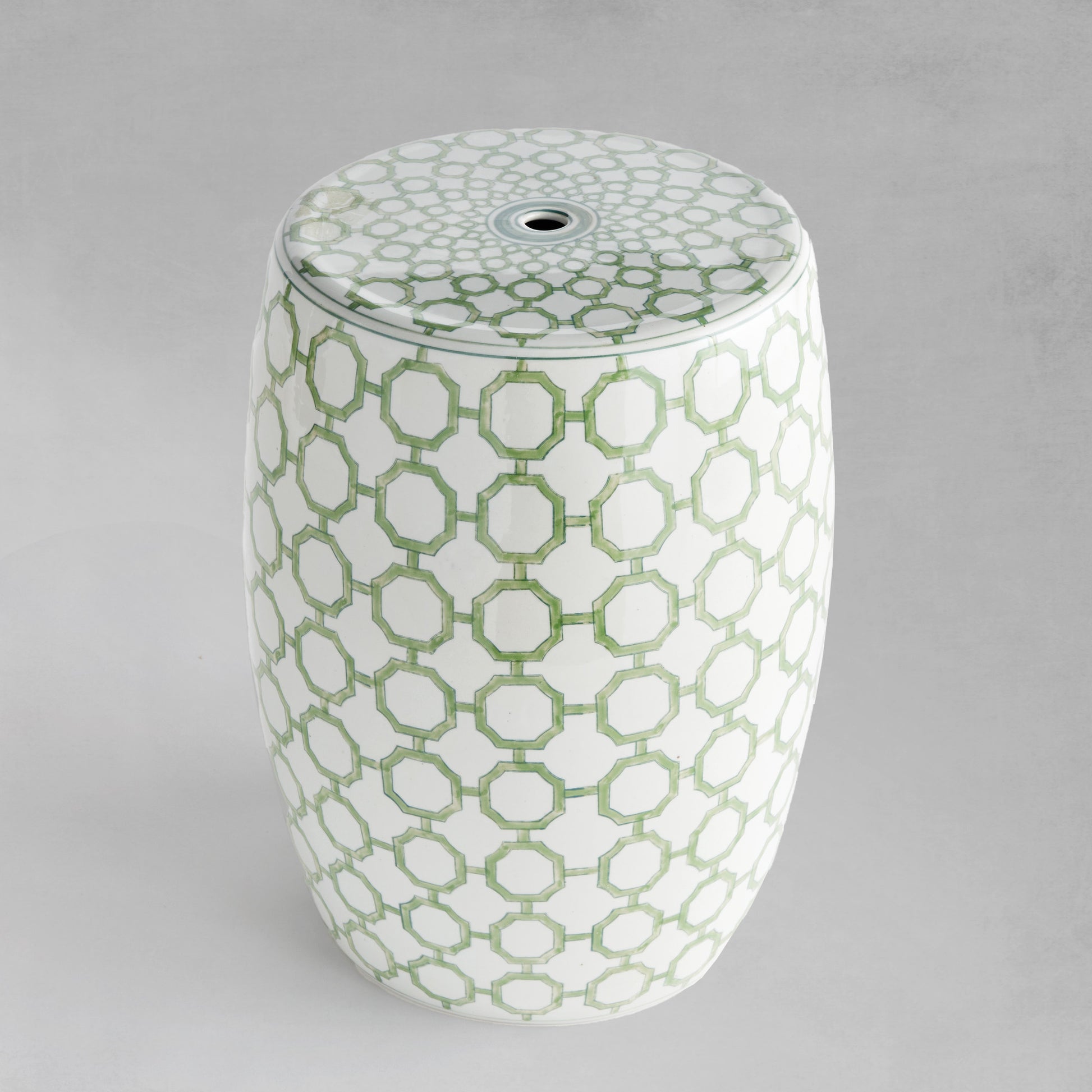 Chinoiserie green and white porcelain side table with gray background.