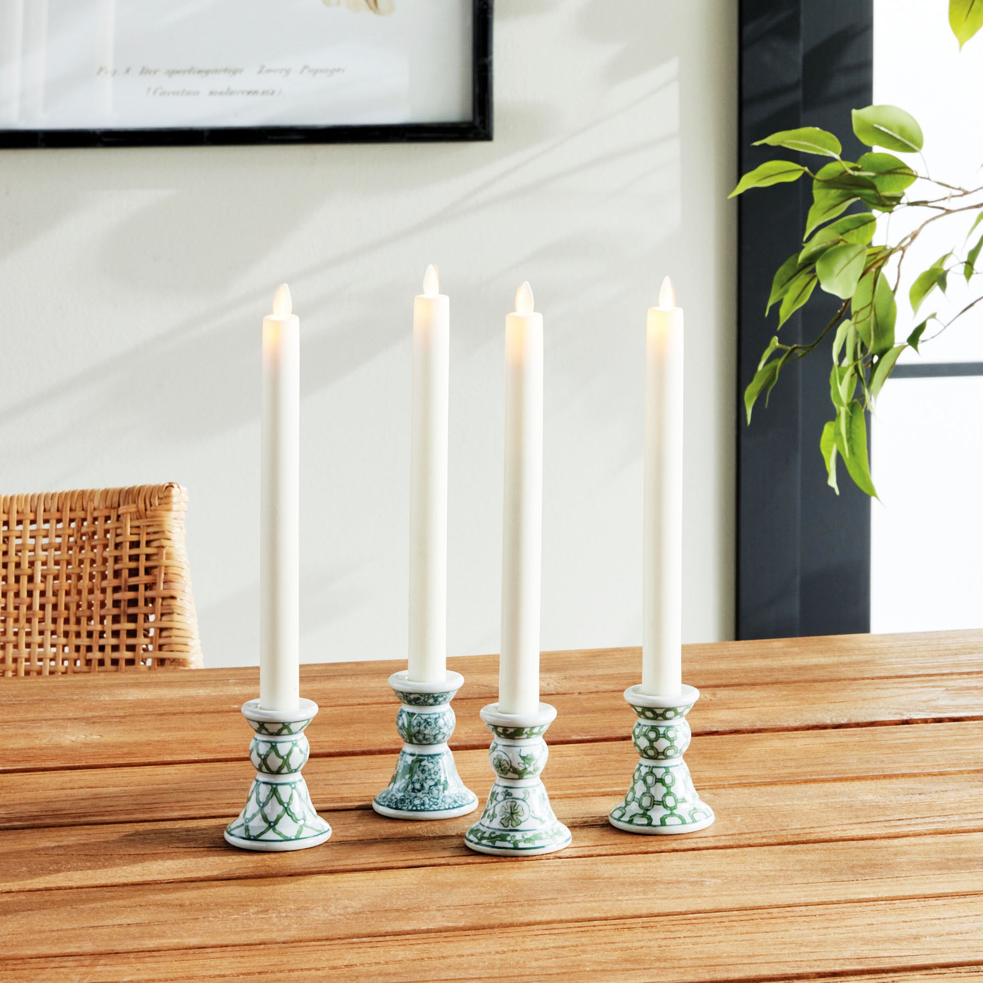 Set of 4 chinoiserie green and white porcelain taper holders stylized in dining room.