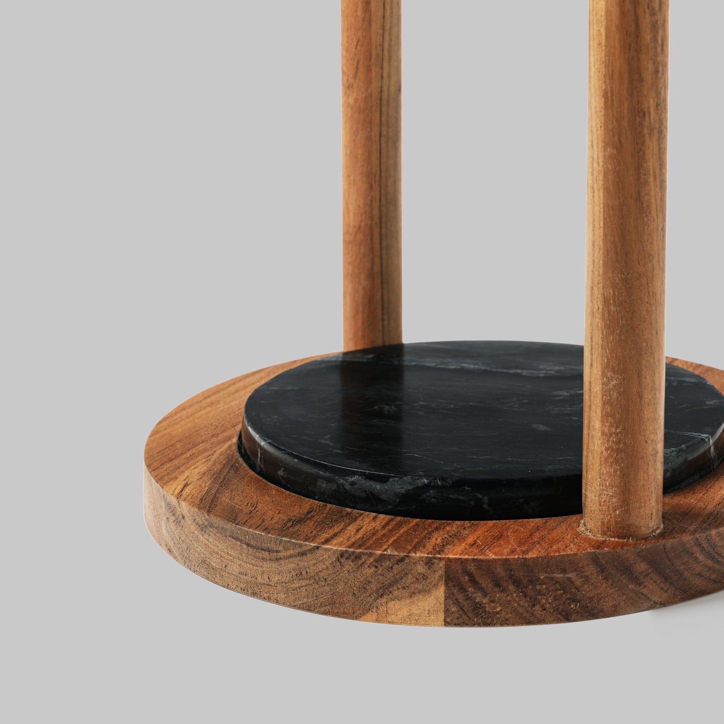 Contemporary acacia wood and black marble accent table, bottom view.