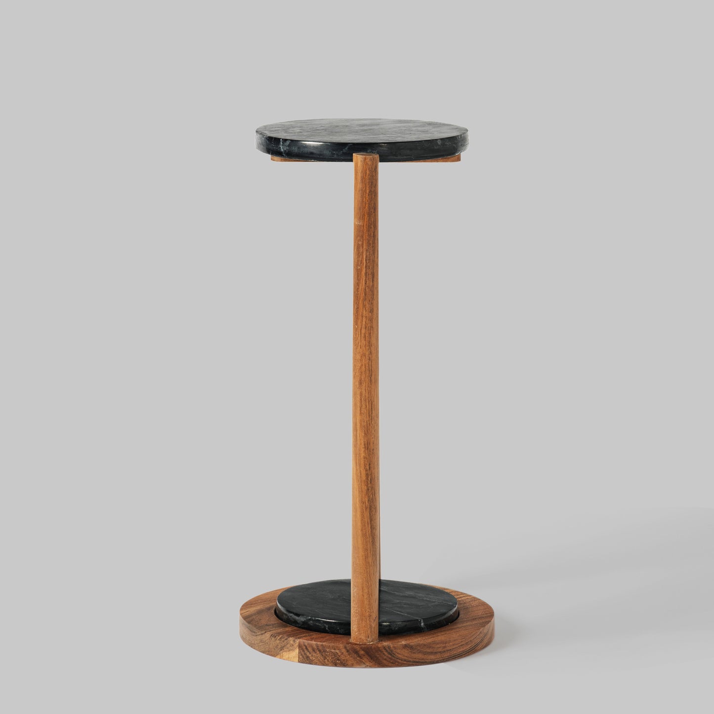 Contemporary acacia wood and black marble accent table, side view.