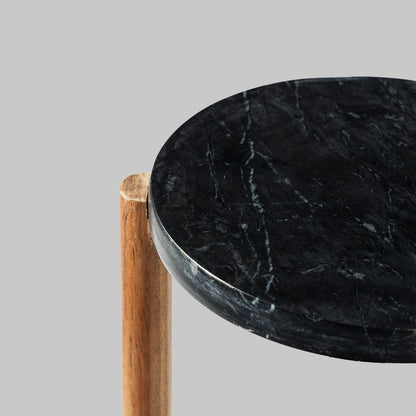 Contemporary acacia wood and black marble accent table, top view.