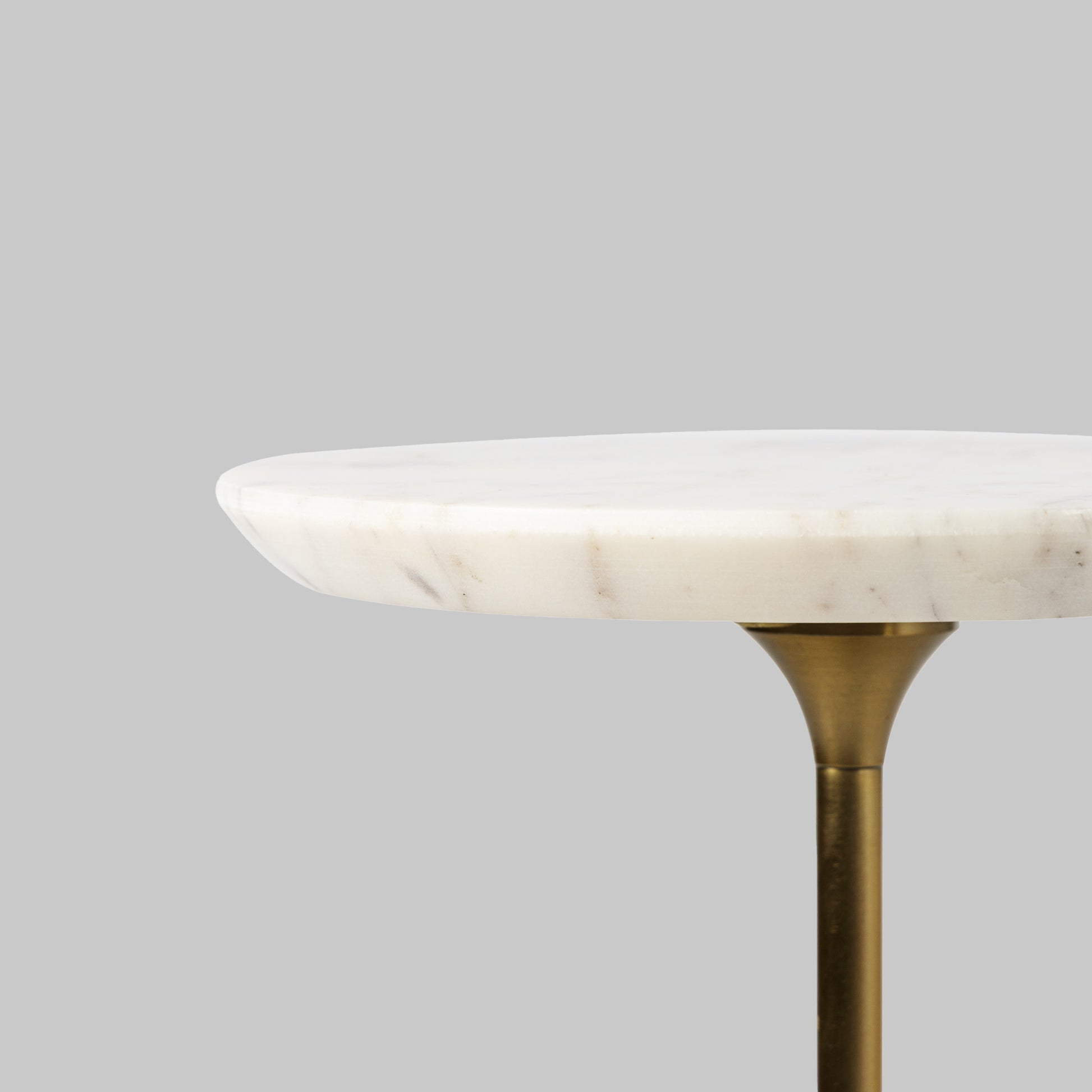 Contemporary antique brass and marble accent table, closeup side view of white marble top.