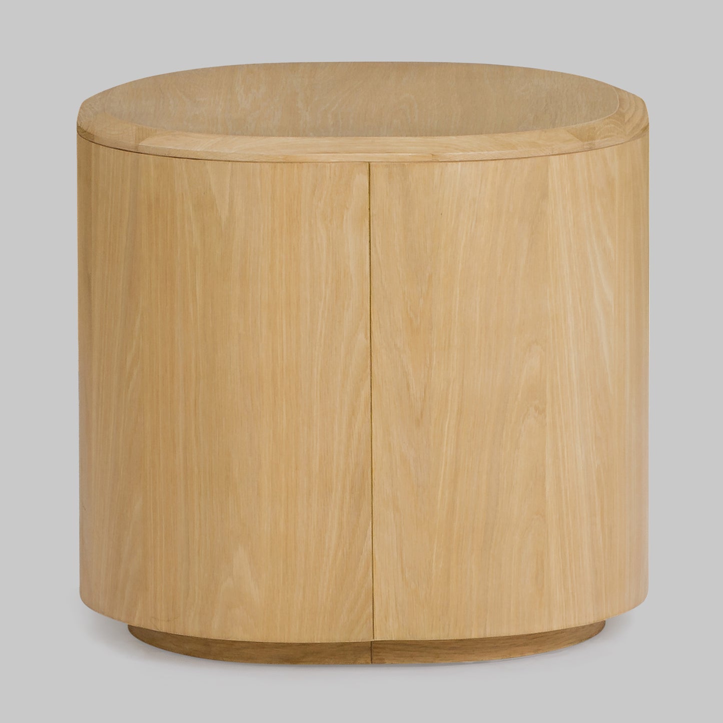 Contemporary round oak side table, natural finish, back view.