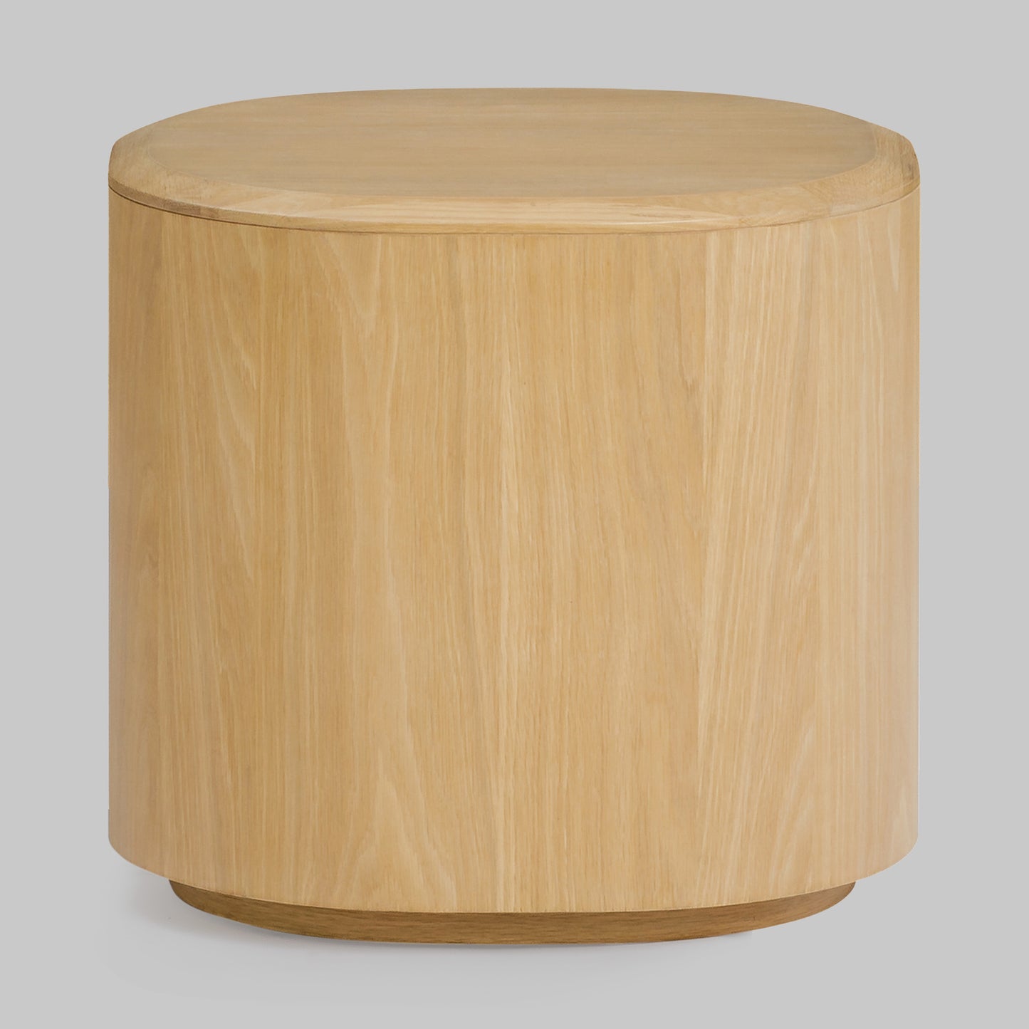 Contemporary round oak side table, natural finish, front view.