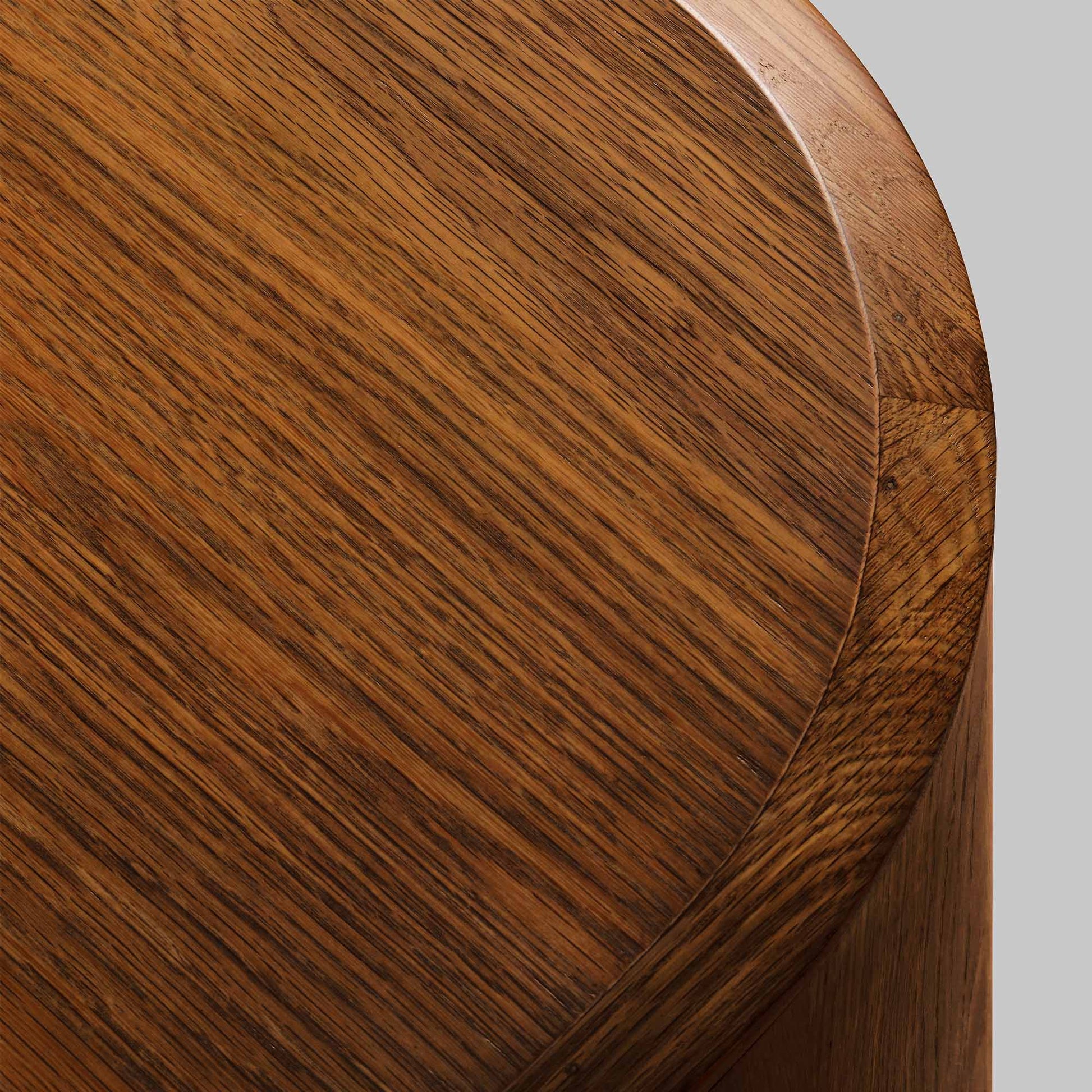 Contemporary round oak side table, walnut finish, top view.