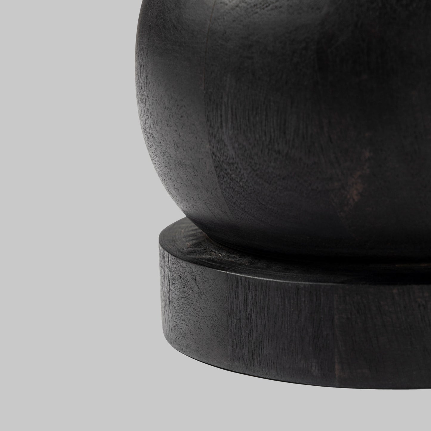 Contemporary stacked black marble accent table, closeup view of table base.