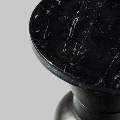 Contemporary stacked black marble accent table, closeup view of marble top.