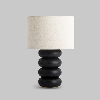 Contemporary stacked wood ring table lamp with black finish.