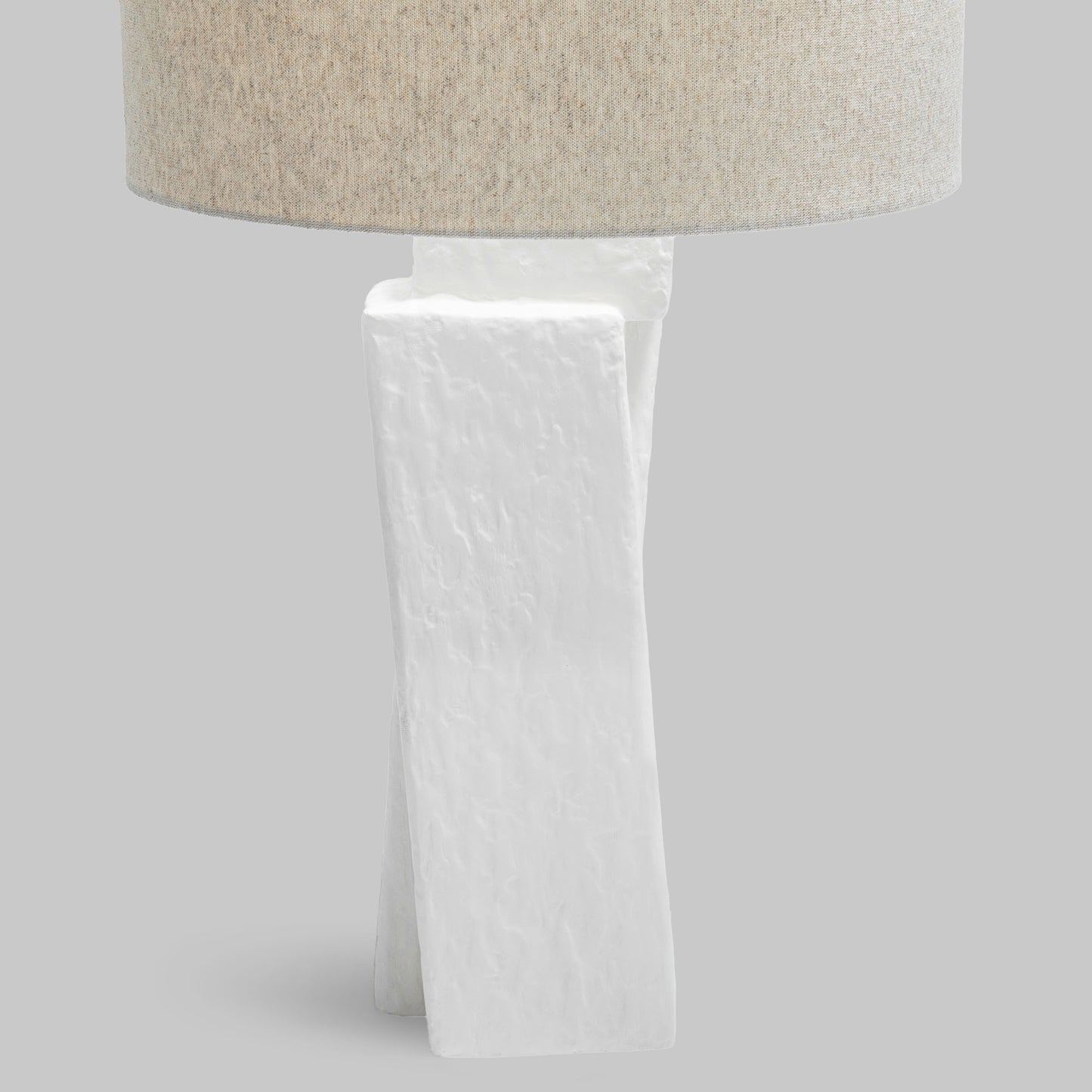 Contemporary white plaster table lamp, closeup view of lamp base.