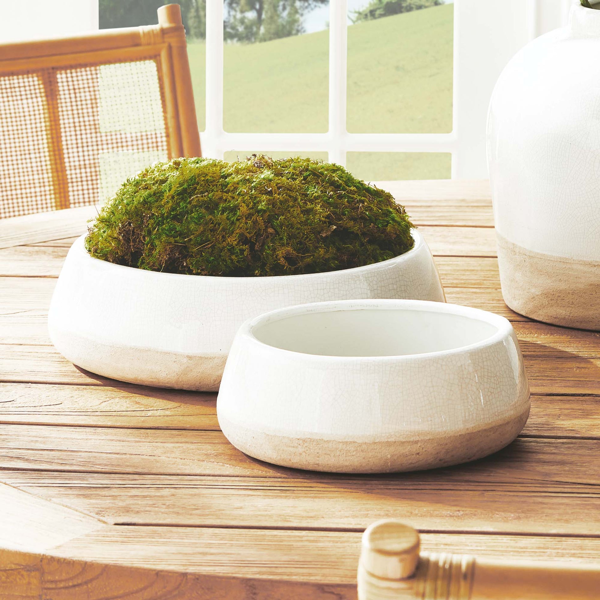 Crackle glaze terracotta bowl set stylized on table.