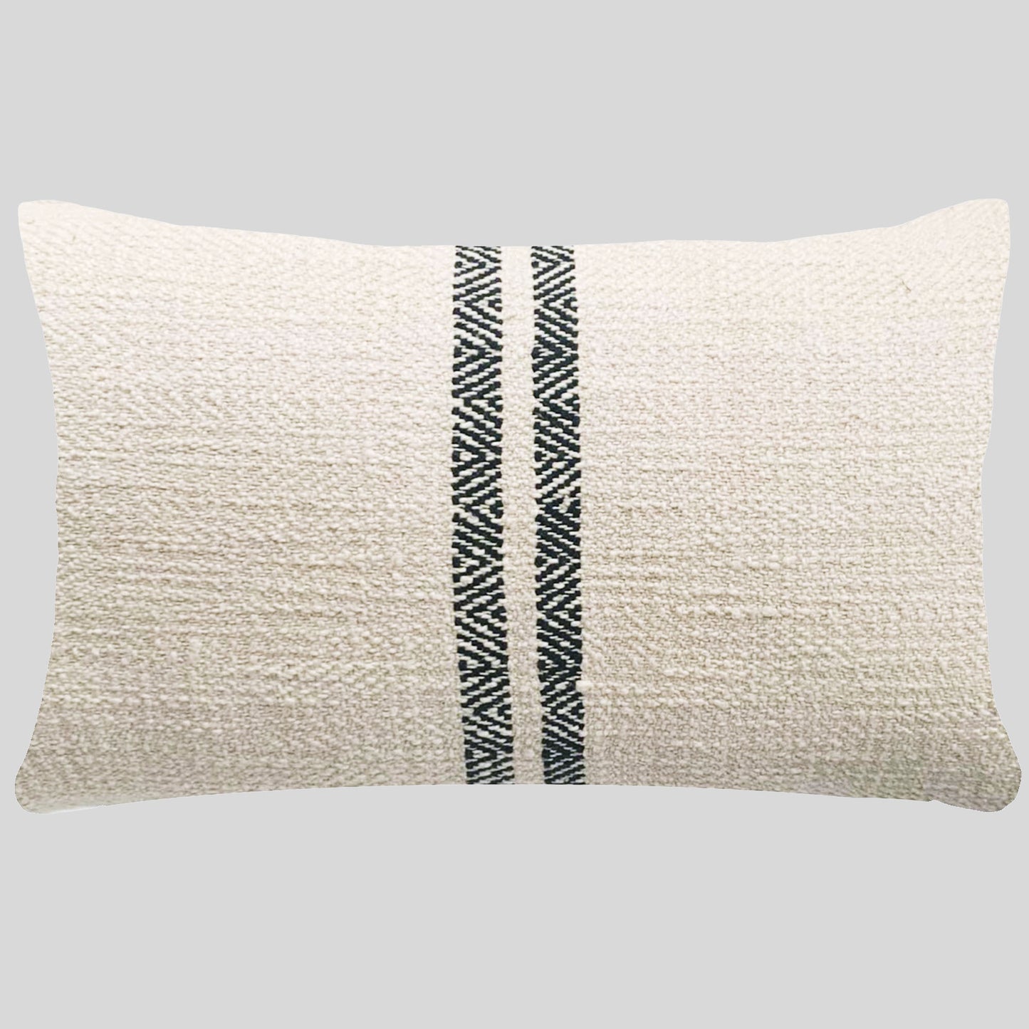 Cream double striped lumbar pillow with gray background.