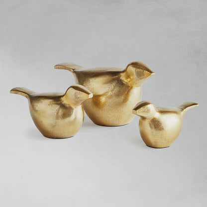 Decorative gold bird objects, set of 3, with gray background.