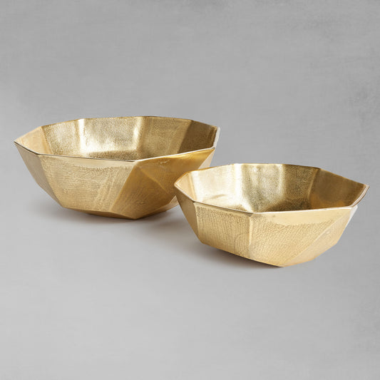 Decorative gold geometric bowls with gray background.