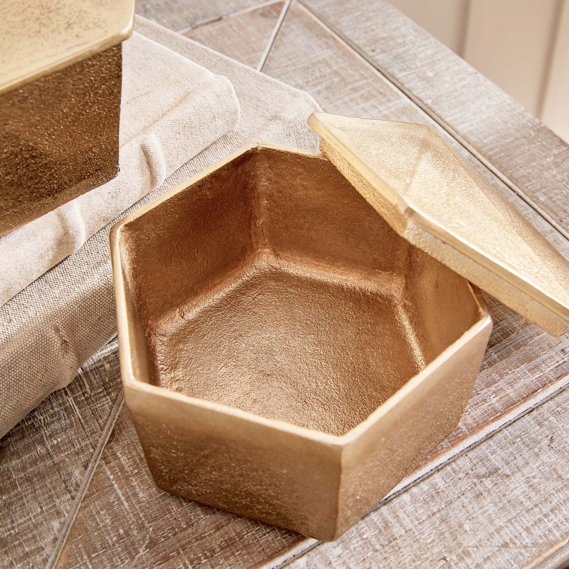 Decorative gold geometric lidded boxes, interior view.