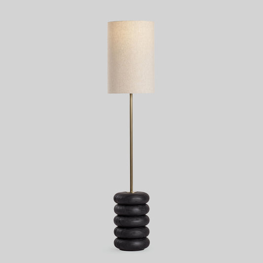 Floor lamp with a stacked circular wood base on a light gray background.