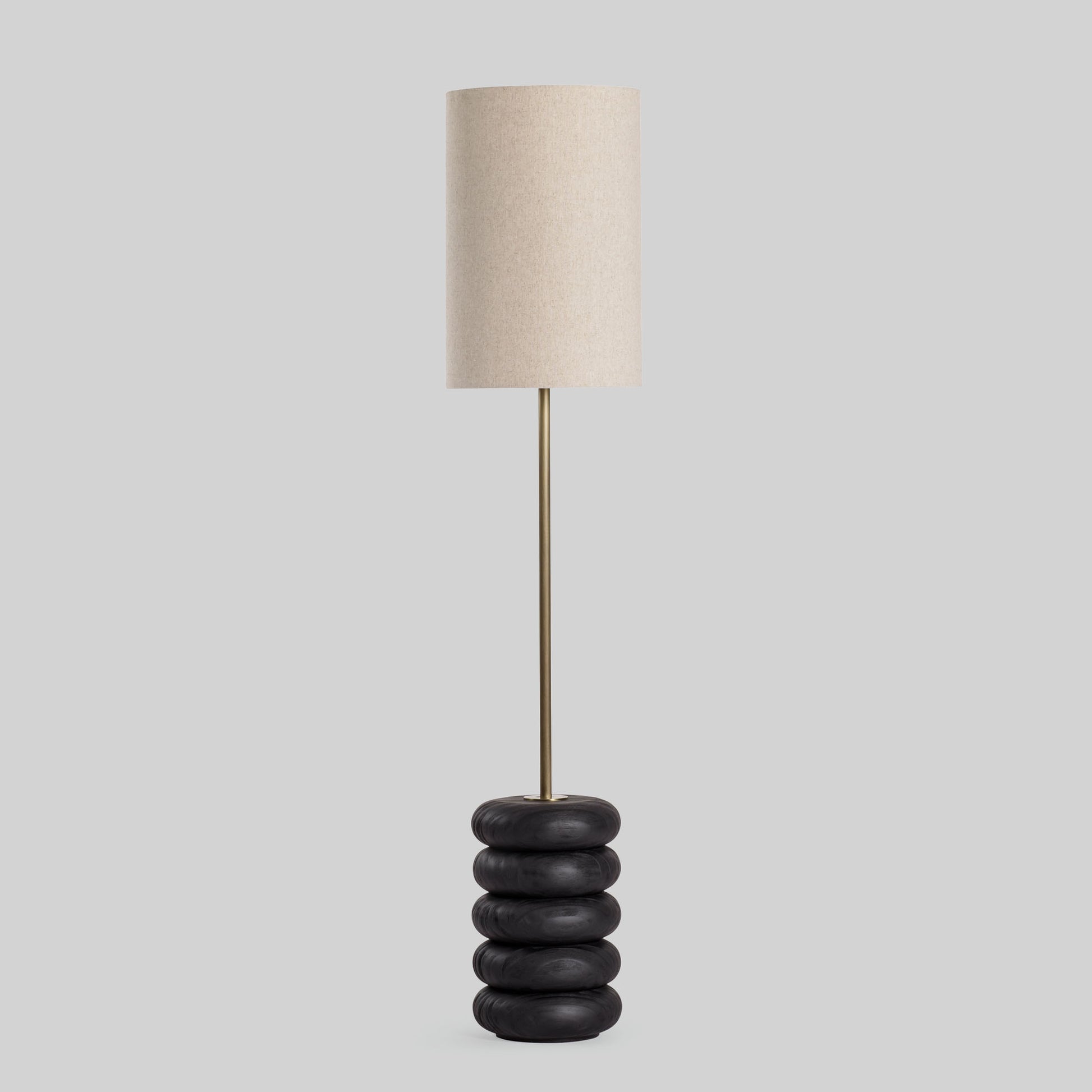 Floor lamp with a stacked circular wood base on a light gray background.