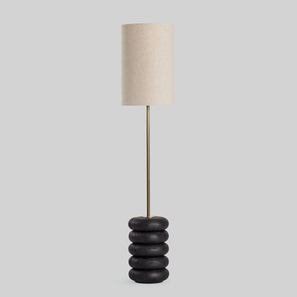 Floor lamp with a stacked circular wood base on a light gray background.
