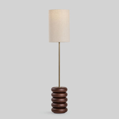 Floor lamp with a stacked circular wood base on a light gray background.