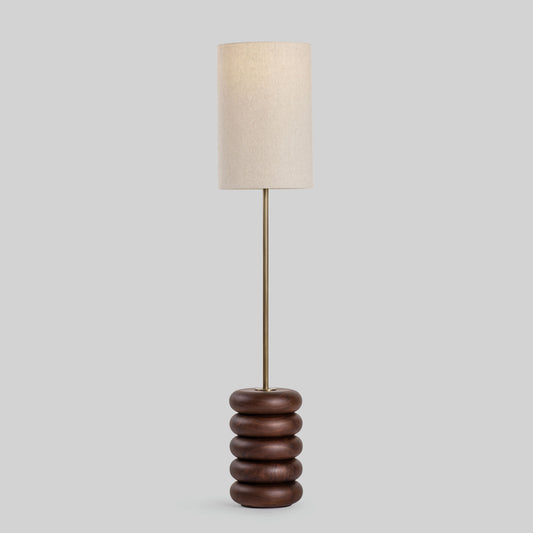 Floor lamp with a stacked circular wood base on a light gray background.