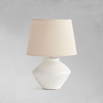 Glazed white mini lamp with gray background.