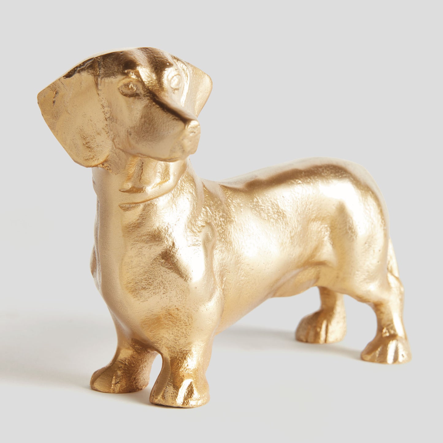 Gold dachshund dog sculpture - stylish home accent (Image1).