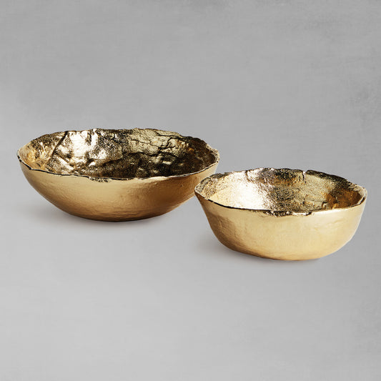 Hammered decorative gold bowls with gray background.